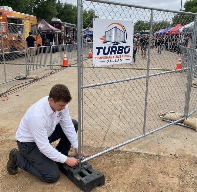 Turbo Temporary Fence Rental Dallas team installing chain link temporary fence panels at a construction site